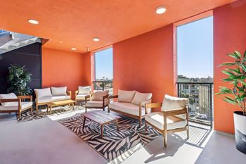 A patio with orange walls and furniture.